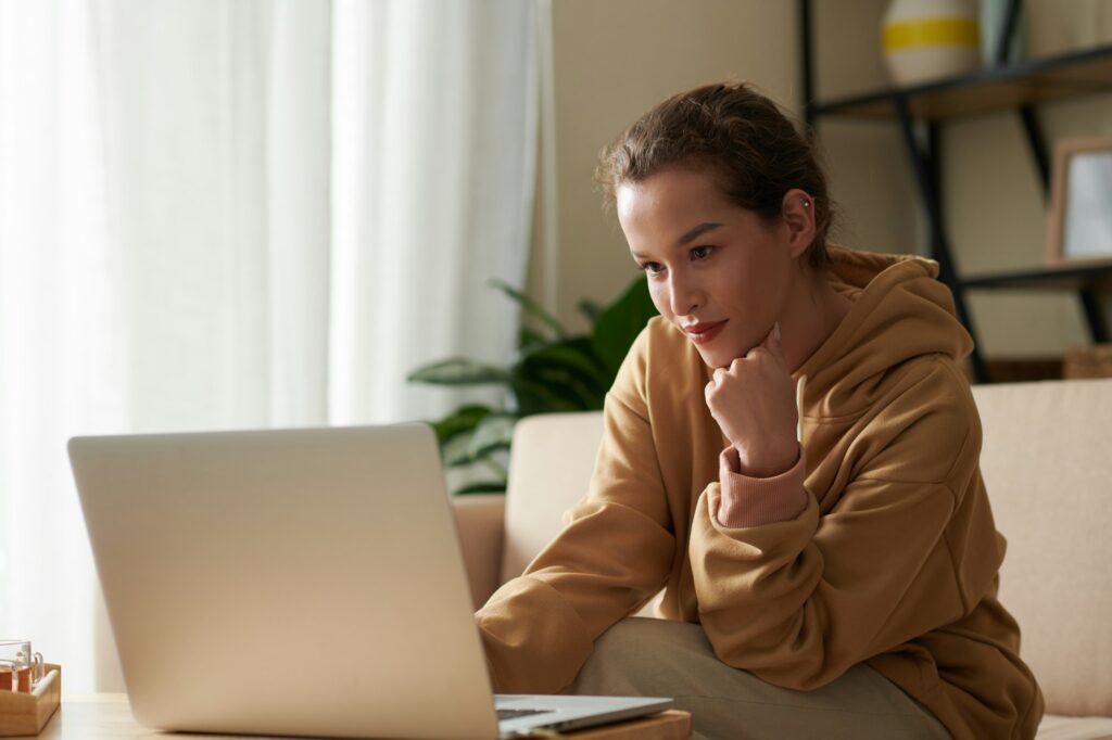 Woman Browsing Internet on Laptop